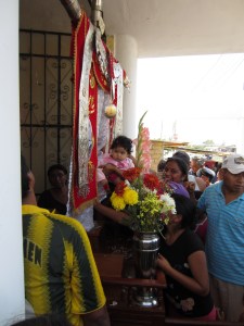 My host sister holding my niece up to the cross.