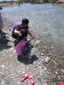 My host sister and niece running their hands through the river water.